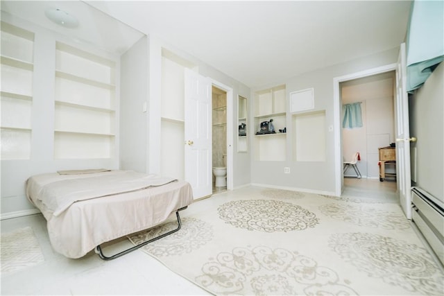 bedroom featuring ensuite bathroom and a baseboard heating unit