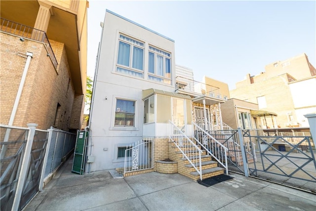 exterior space featuring fence and stucco siding