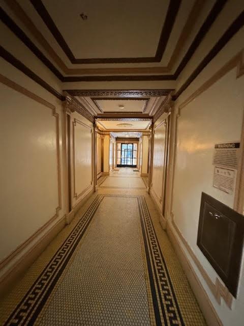 hallway featuring crown molding