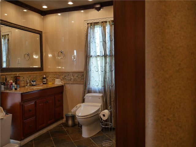 bathroom featuring decorative backsplash, tile patterned floors, toilet, and vanity