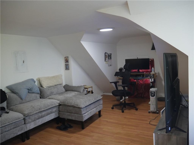 office space with vaulted ceiling and light wood-type flooring