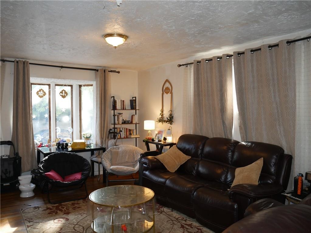 living room featuring hardwood / wood-style flooring and a textured ceiling