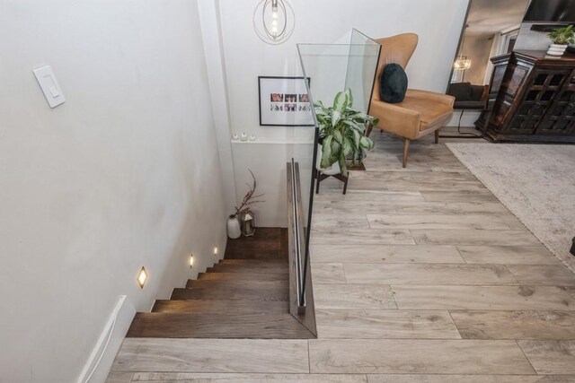 stairway with hardwood / wood-style flooring