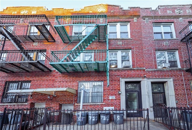 view of building exterior featuring a fenced front yard and cooling unit