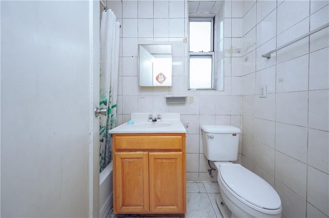 full bathroom with vanity, toilet, tile walls, and shower / bath combo