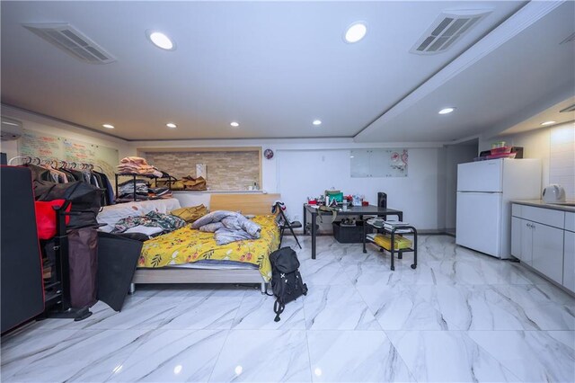 bedroom with marble finish floor, freestanding refrigerator, recessed lighting, and visible vents
