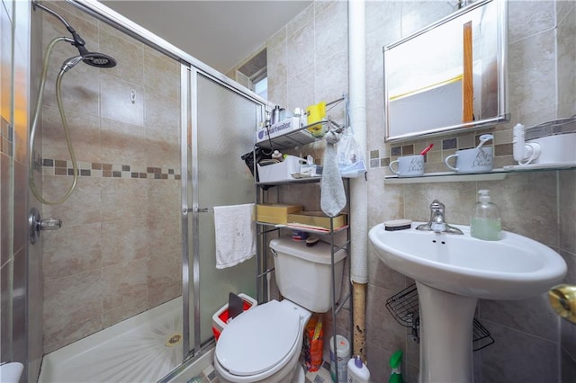 bathroom with decorative backsplash, a stall shower, toilet, and tile walls
