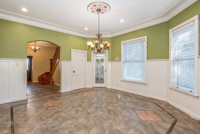 unfurnished dining area featuring crown molding and a healthy amount of sunlight