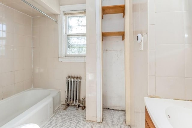 bathroom featuring vanity, radiator heating unit, and shower / bathtub combination