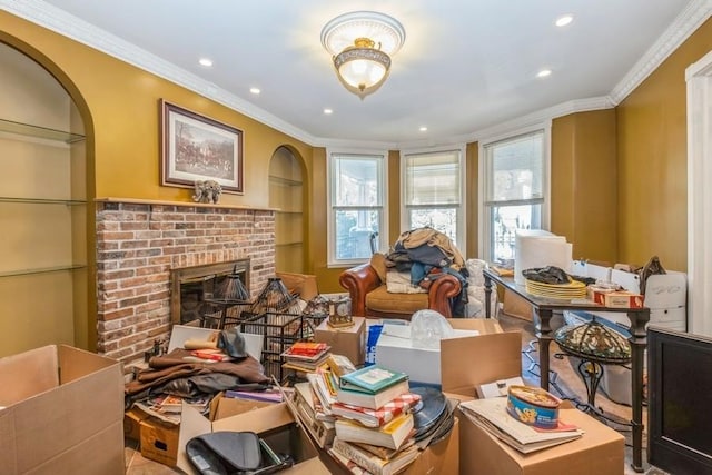 miscellaneous room featuring built in features, crown molding, and a fireplace