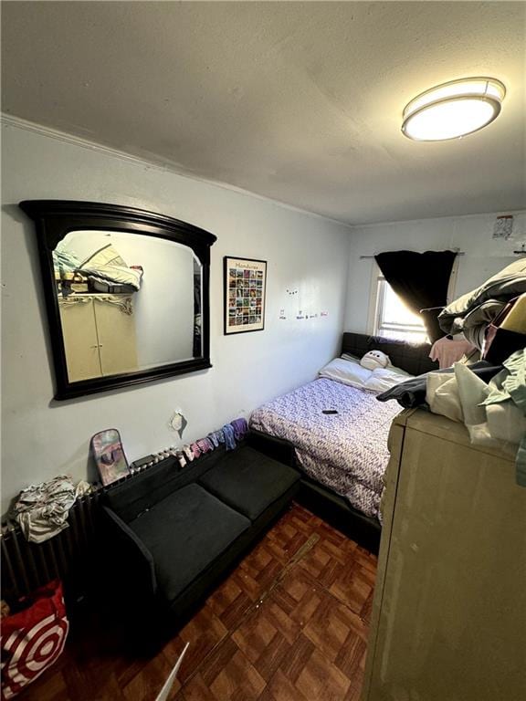 bedroom featuring dark parquet floors