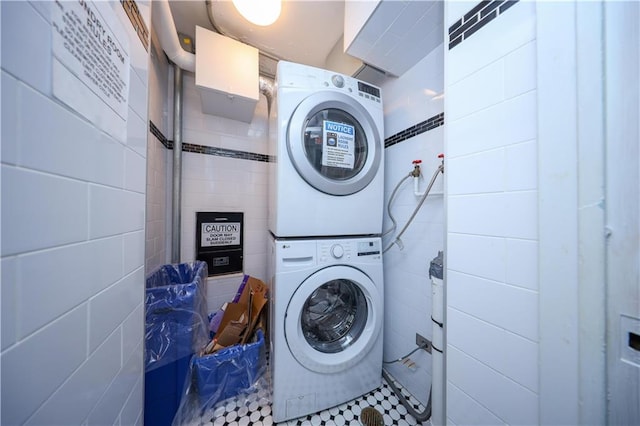 clothes washing area with stacked washer / drying machine