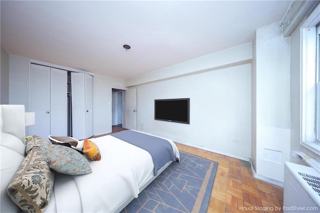 bedroom featuring a closet and dark parquet floors