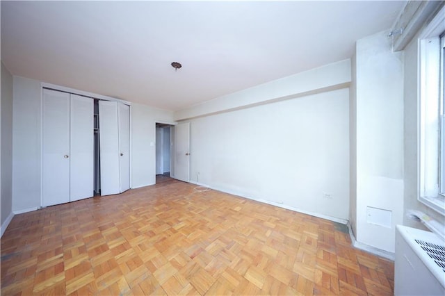 unfurnished bedroom featuring light parquet floors