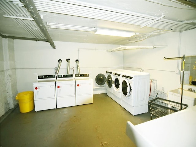 clothes washing area with washer and dryer and sink