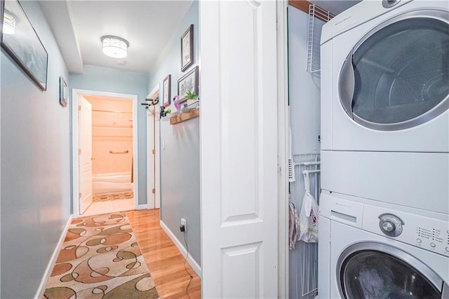 washroom featuring stacked washer / dryer and hardwood / wood-style floors