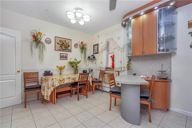 dining room featuring light tile patterned flooring and a baseboard radiator