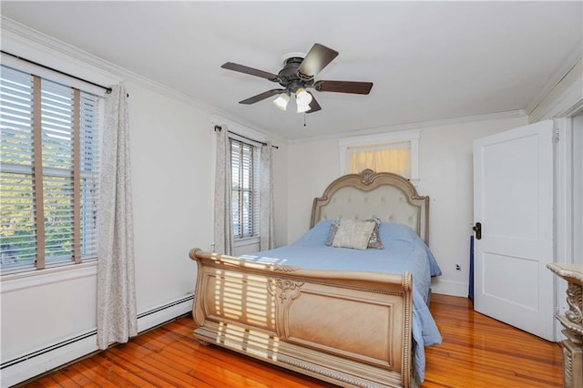 bedroom featuring multiple windows, ceiling fan, a baseboard radiator, and light wood-type flooring