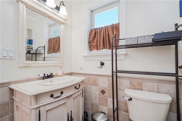 bathroom with plenty of natural light and tile walls