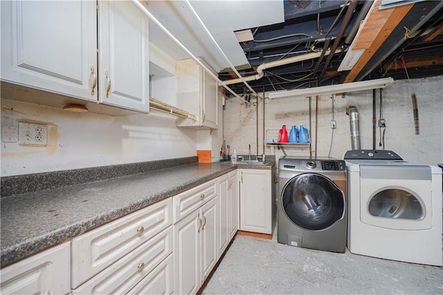 laundry room with cabinets, separate washer and dryer, and sink