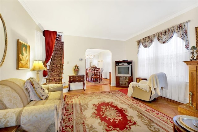 living room with parquet flooring and ornamental molding