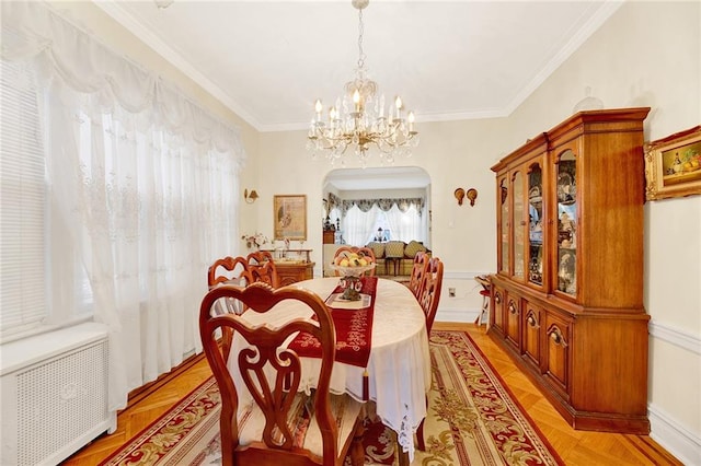 dining room with radiator, light parquet flooring, an inviting chandelier, and ornamental molding