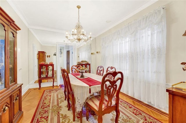 dining room with a chandelier, crown molding, and light parquet flooring