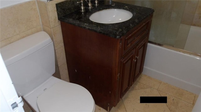 full bathroom featuring vanity, toilet, tile patterned floors, and bath / shower combo with glass door