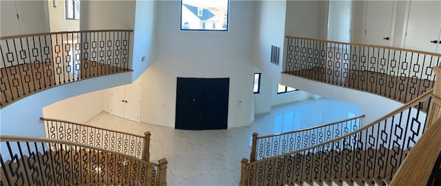interior space with visible vents and a towering ceiling