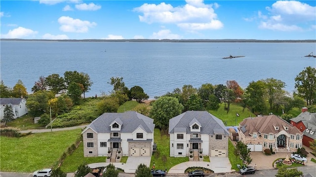 bird's eye view featuring a water view and a residential view