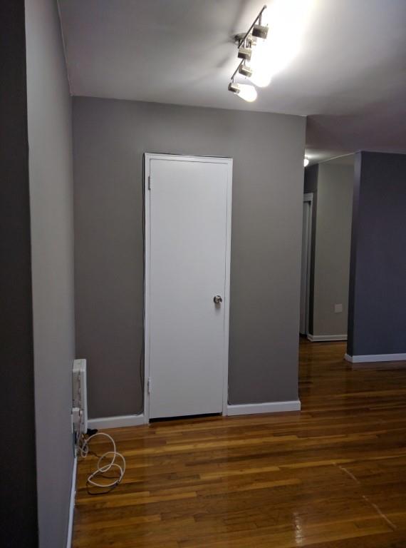 empty room with dark hardwood / wood-style flooring