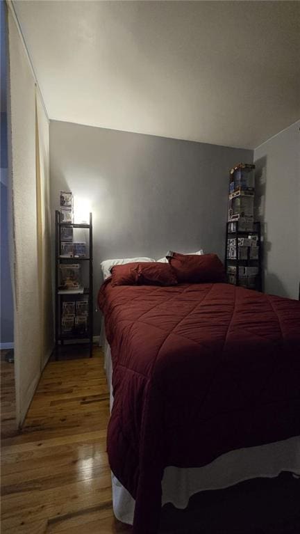 bedroom with hardwood / wood-style floors