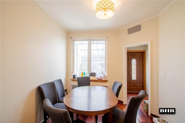 dining space featuring crown molding and hardwood / wood-style floors