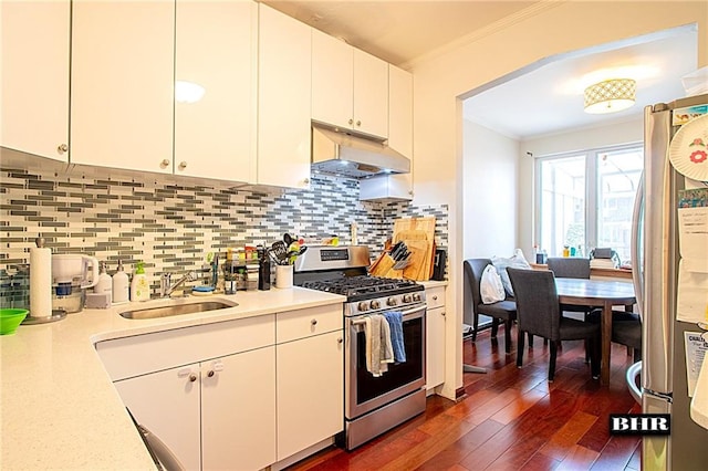 kitchen featuring sink, tasteful backsplash, ornamental molding, appliances with stainless steel finishes, and white cabinets