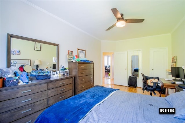 bedroom with crown molding, ceiling fan, and light hardwood / wood-style flooring