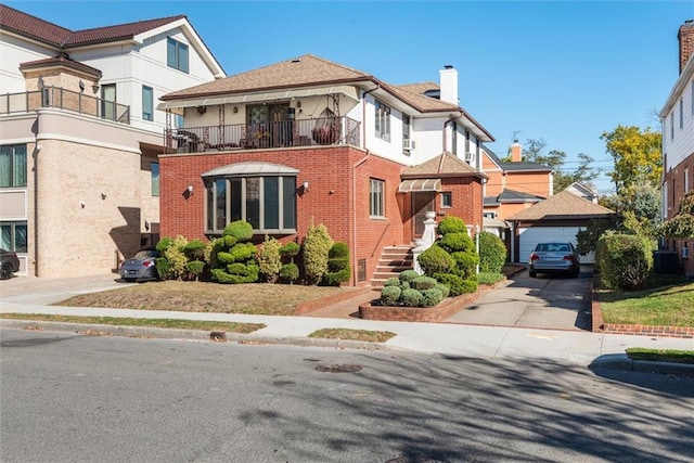 view of front of property featuring a balcony and central air condition unit