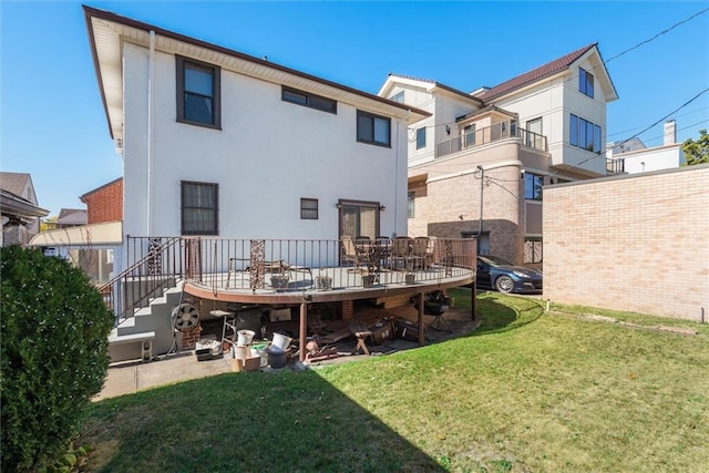 back of house with a lawn and a deck