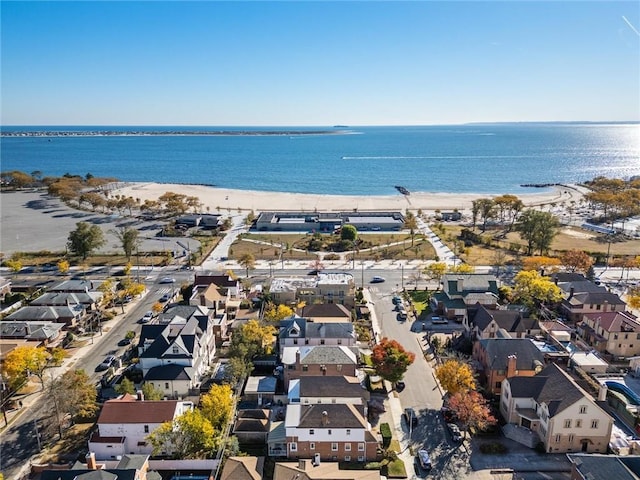 birds eye view of property featuring a water view and a beach view