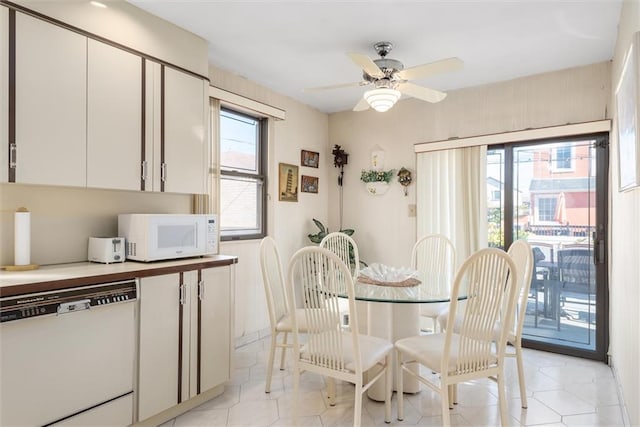 dining room featuring light tile patterned floors, a wealth of natural light, and ceiling fan