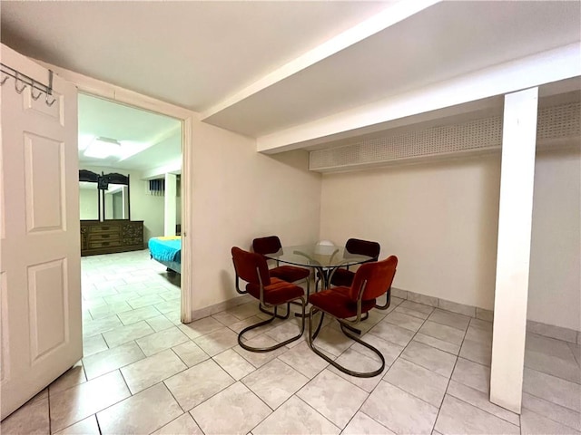 dining area with light tile patterned flooring and baseboards