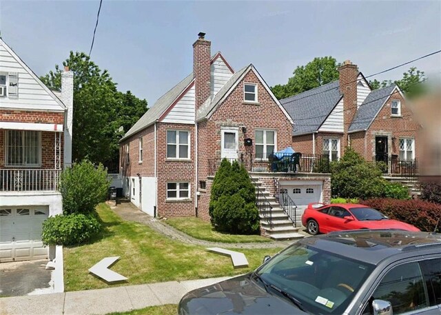 view of front of house featuring a garage and a front lawn