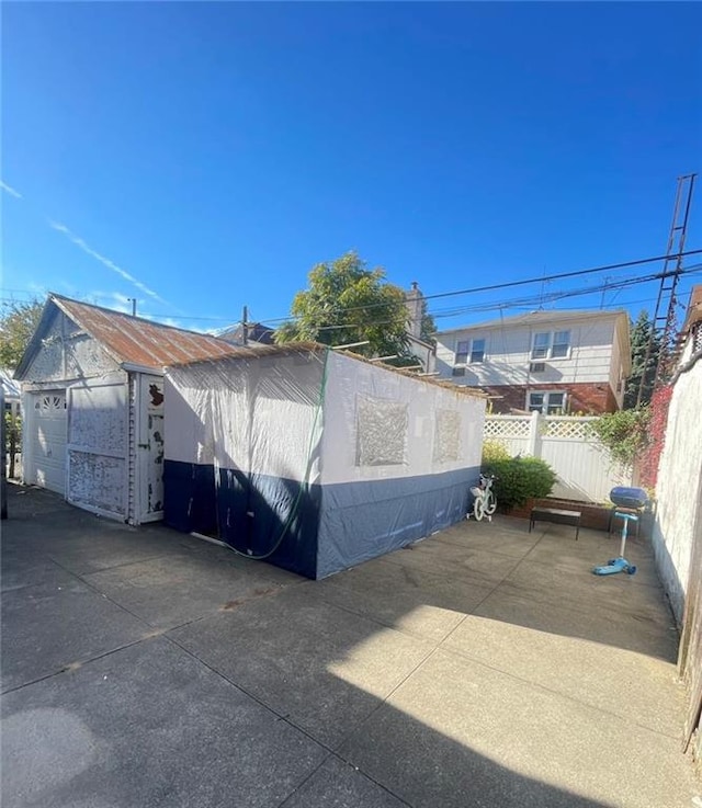 detached garage featuring fence