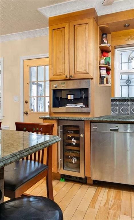 bar with light wood-type flooring, wine cooler, ornamental molding, and stainless steel dishwasher