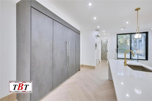 hallway with a wall of windows, an AC wall unit, sink, and light parquet floors