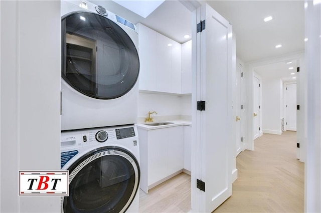 washroom featuring sink and stacked washer and clothes dryer