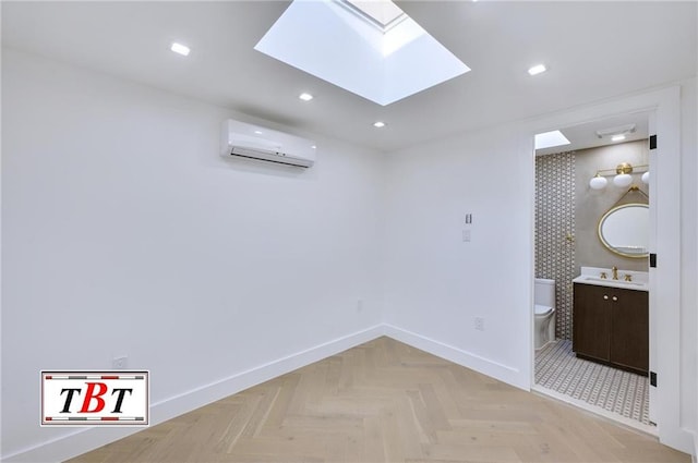 interior space featuring an AC wall unit, a skylight, sink, and light parquet flooring