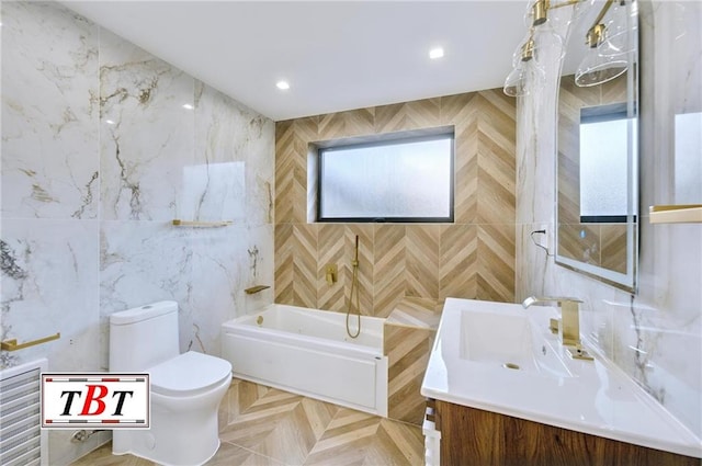 bathroom with vanity, a bathtub, toilet, and tile walls