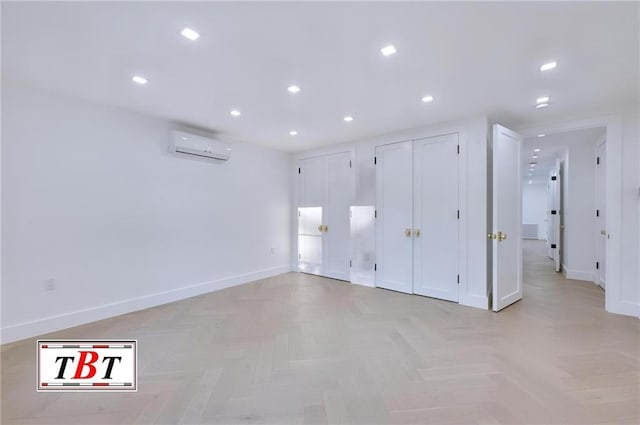 empty room featuring a wall mounted AC and light parquet flooring