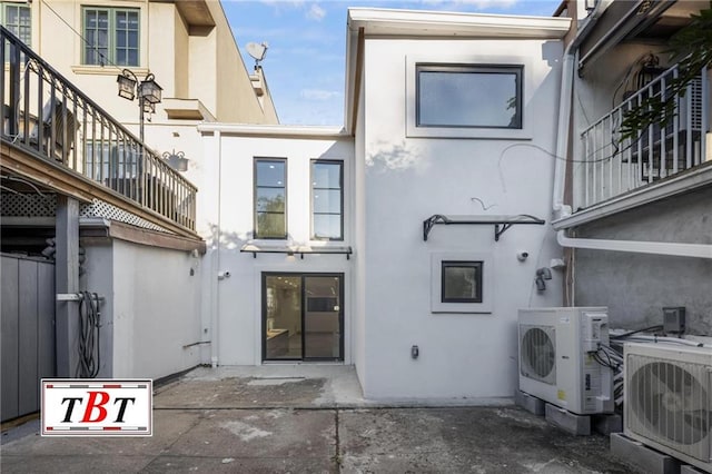 rear view of property with ac unit