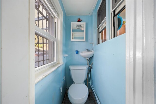 bathroom featuring sink, tile patterned flooring, and toilet